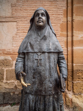 Bronze statue of Saint Angela de la Cruz (Sor Angela de la Cruz) standing outside the historic Iglesia de Santa Maria la Mayor in the old town of Ronda, Spain.