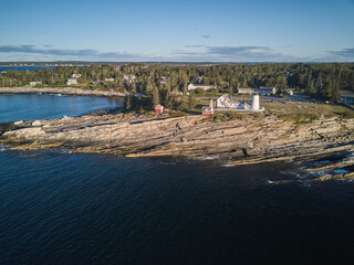 Aerial drone image of the Pemaquid lighthouse and point on the Maine Coast at sunrise