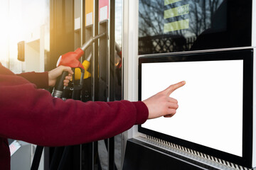 Self-service filling station. A man using a touchscreen