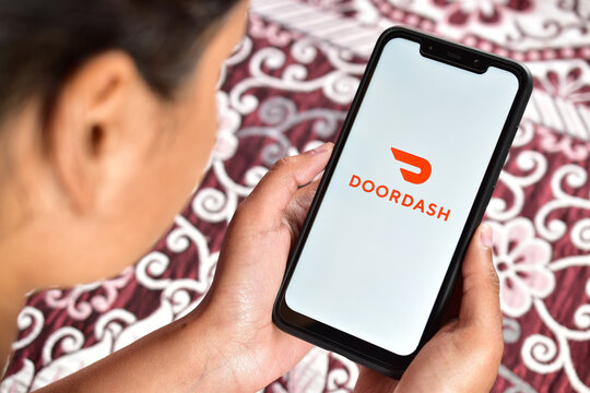 Girl using doordash application on smartphone, online food delivery app