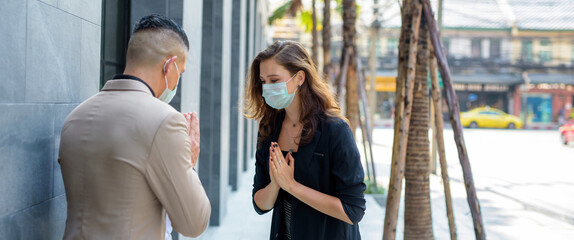 Businessman wearing a mask pretend greet The symbol Greeting.Of Thailand.