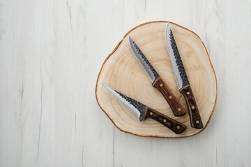 Forged butchers knives on wooden stump