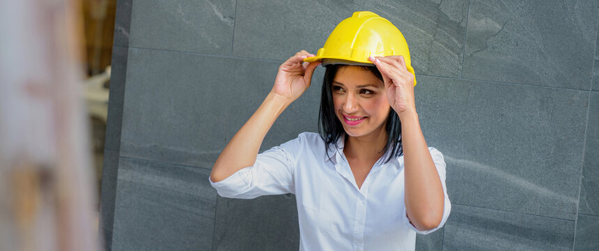 smart woman Exterior designer smiling and removing construction helmet. - Powered by Adobe