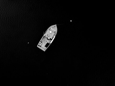 Single Lobster boat in Rockland Harbor Maine as seen from an aerial drone image