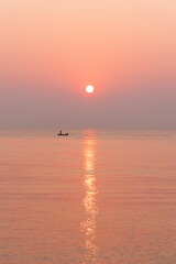 Amazing sunset over the beach. The sun rises over sea.  Pastel tone