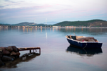 Naklejka na ściany i meble Boat and Dikili Candarli view at sunset