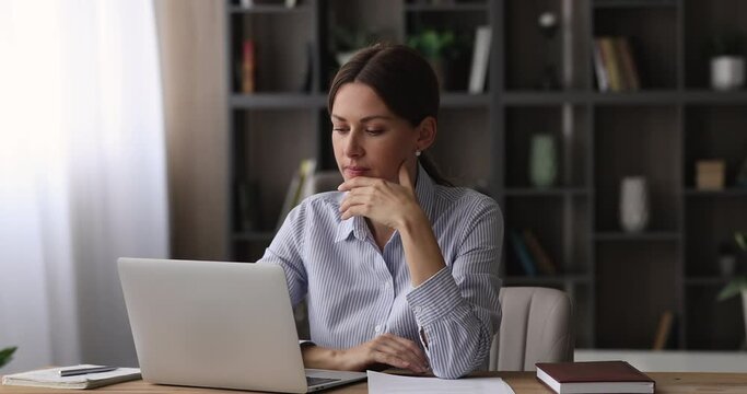 Frustrated unhappy young business lady reading bank loan rejection, feeling desperate about financial problems. Confused 30s woman getting dismissal notice or letter with bad news, pondering in office