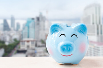 piggy bank over blurred city background.