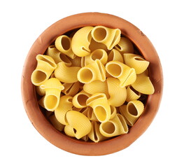 Pasta lumaconi rigati pile in clay pot isolated on white background, top view