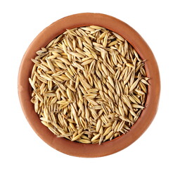 Unpeeled oat grains, groats in clay pot isolated on white background, top view