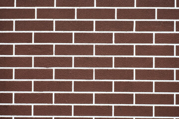 Brown brick wall with white grout lines pattern
