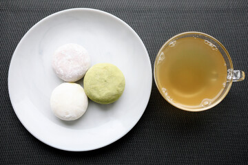 Fototapeta na wymiar Japanese ice cream Mochi in rice dough. Traditional Japanese dessert on a black slate