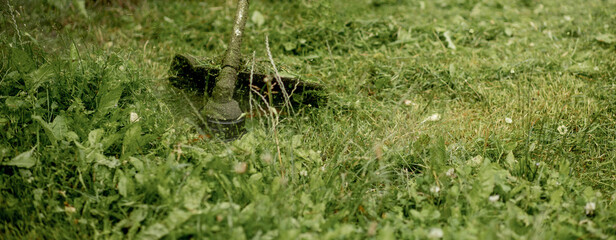 Man mowing the grass, the mower close up