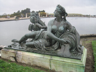 Obraz premium Beautiful sculpture in the Versailles Garden on a rainy day. Travel to European Union. UNESCO World Heritage Site.