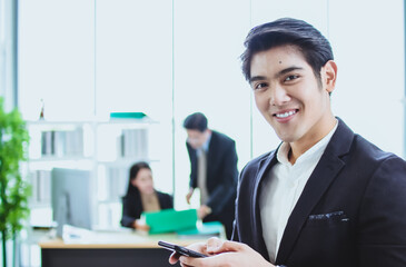 young asian business man. smile face. sitting and standing in office. talk business. phone call with official working background. looking camera cross arm copy space