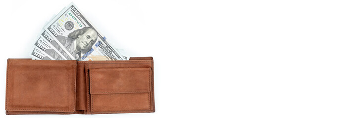 A wallet full of money. Many one hundred dollar banknotes in brown wallet on white background. Banner, flat lay