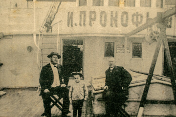Russia, Caspian Sea - CIRCA 1910-1917: Family members of a ship crew posing on the Ivan Prokofjev oil tanker ship which was used for transporting unrefined crude oil from extraction to refineries