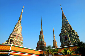Fototapeta premium Group of Large Stupas Calls Phra Maha Chedi Si Rajakarn, Dedicated to the First Four Kings of Chakri Dynasty, Located in Wat Pho Temple, Bangkok, Thailand