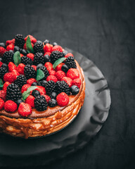 a cheesecake with an assortment of berries