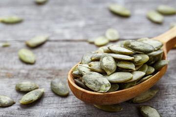 Kernels of pumpkin seeds in a wooden spoon