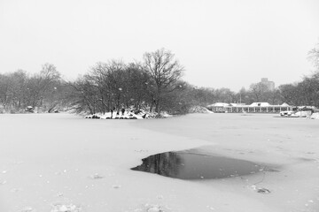Black and White Photo of the Lake at Central Park Frozen Over during a Winter Snowstorm in New York City