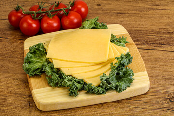 Sliced Gauda cheese over board