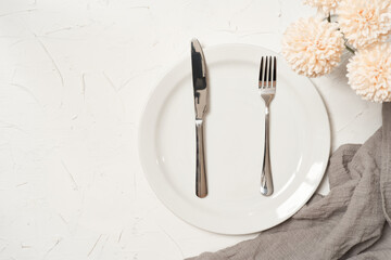 food concept stylish table setting cutlery on white table with silver fork and knife. top view or flat lay 