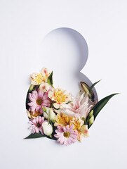 Number 8 with fresh spring flowers with green leaves on bright white background. Minimal Women's...