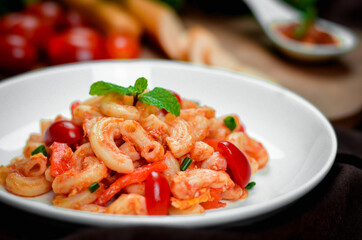Pasta with spicy tomato sauce and basil and sausage.