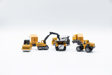 Construction site work vehicles on white background with copy space.