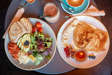 breakfast plate with bread, vegetables and pancakes