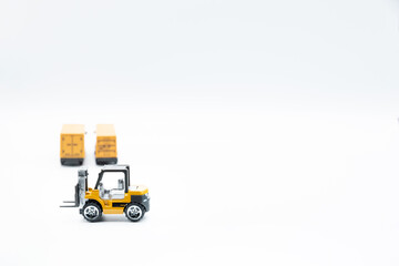 Miniature trucks and forklift for logistics and freight transport, on white background.