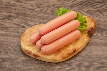 Tasty meat sausages over board