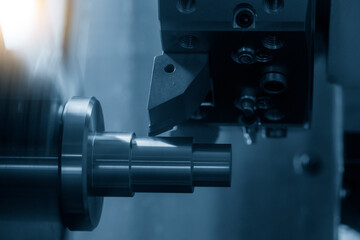 Fototapeta na wymiar The CNC lathe machine cutting the metal cone shape parts. The hi-technology metal working processing by CNC turning machine .
