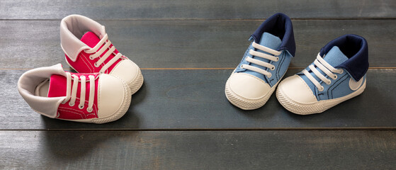 Baby shoes on blue wooden floor color background
