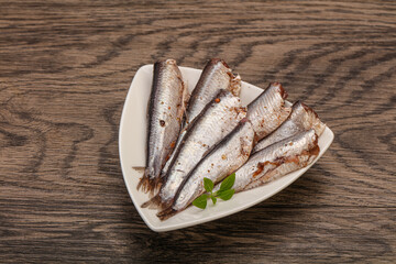 Anchovies in the bowl served basil leaves