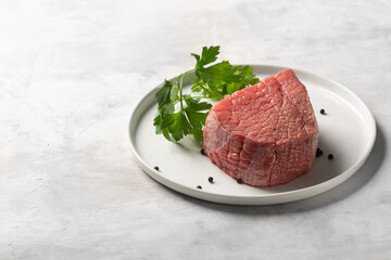 Fresh raw beef on white plate with copy space