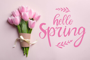 Hello Spring. Beautiful tulips on pink background, top view