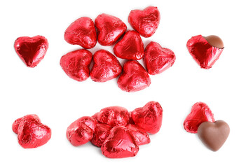 Set with delicious heart shaped chocolate candies on white background, top view