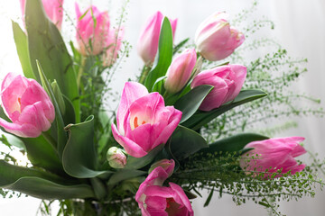 Bouquet of beautiful pink tulips on wooden background
