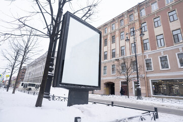 Advertising billboard in winter with white field for advertising