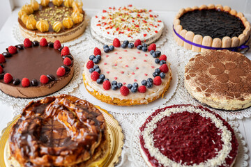 selection of cheesecakes, profiterole, carrot cake, tartlet, fruit cakes for mothersday, valentines day on white background