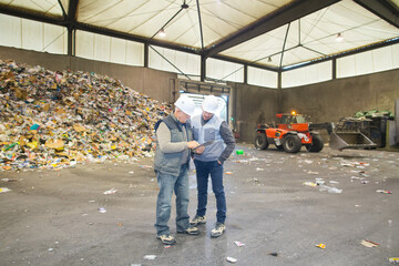 two workers at a recycling plant
