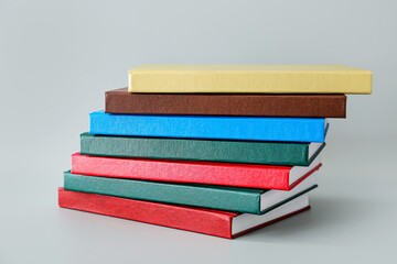 Stack of books on light background