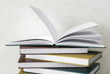 Stack of books on light background