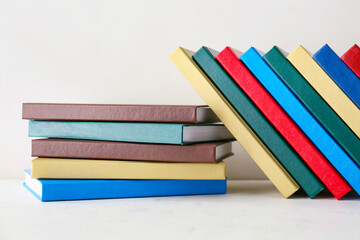 Stack of books on light background