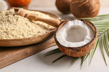 Plate with coconut flour on light background