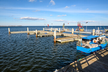 Fototapeta premium Fishong pier in Mechelinki. Mechelinki is a fishing village and a popular tourist destination on the Baltic Sea in Poland