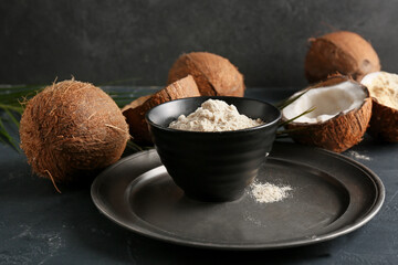 Bowl with coconut flour on dark background