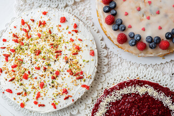 selection of cheesecakes, profiterole, carrot cake, tartlet, fruit cakes for mothersday, valentines day on white background